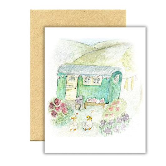 Illustrated card with a green caravan and garden scene on a white background