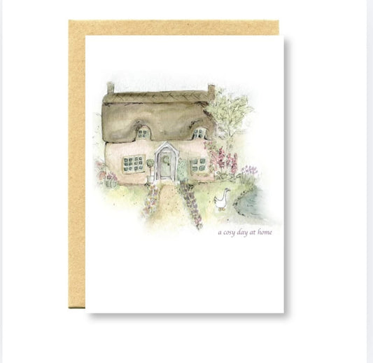 Greeting card with a illustration of a quaint house and garden on a white background.